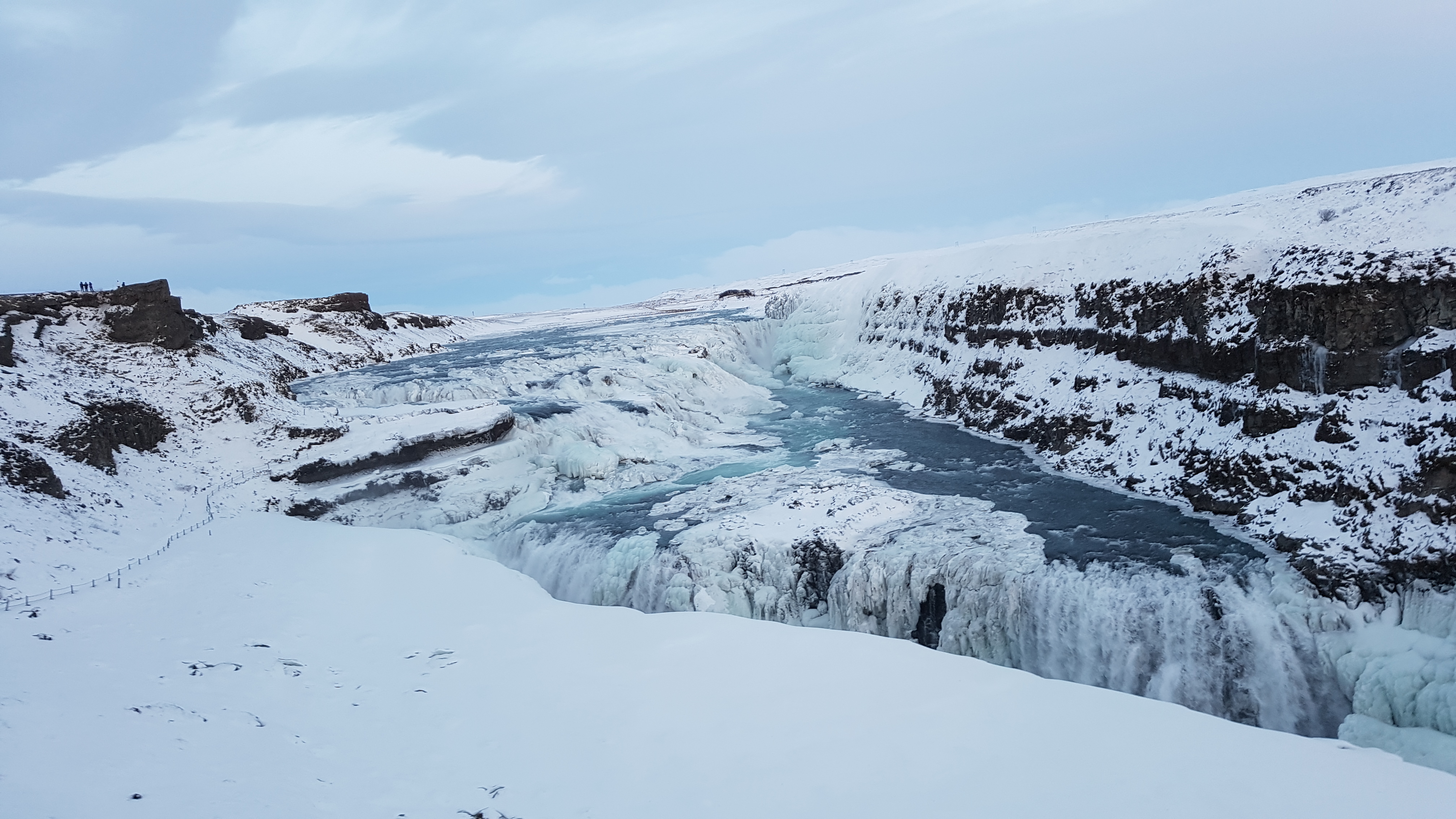 Gullfoss lower cascade plunging into the canyon with rainbow in the mist