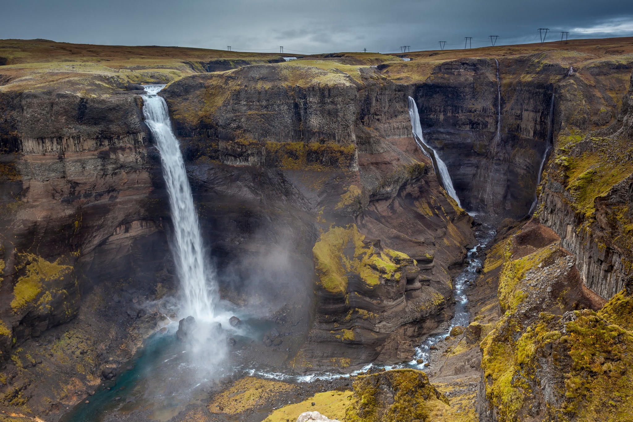 Háifoss and Granni twin waterfalls plunging into a deep canyon with layered basalt walls