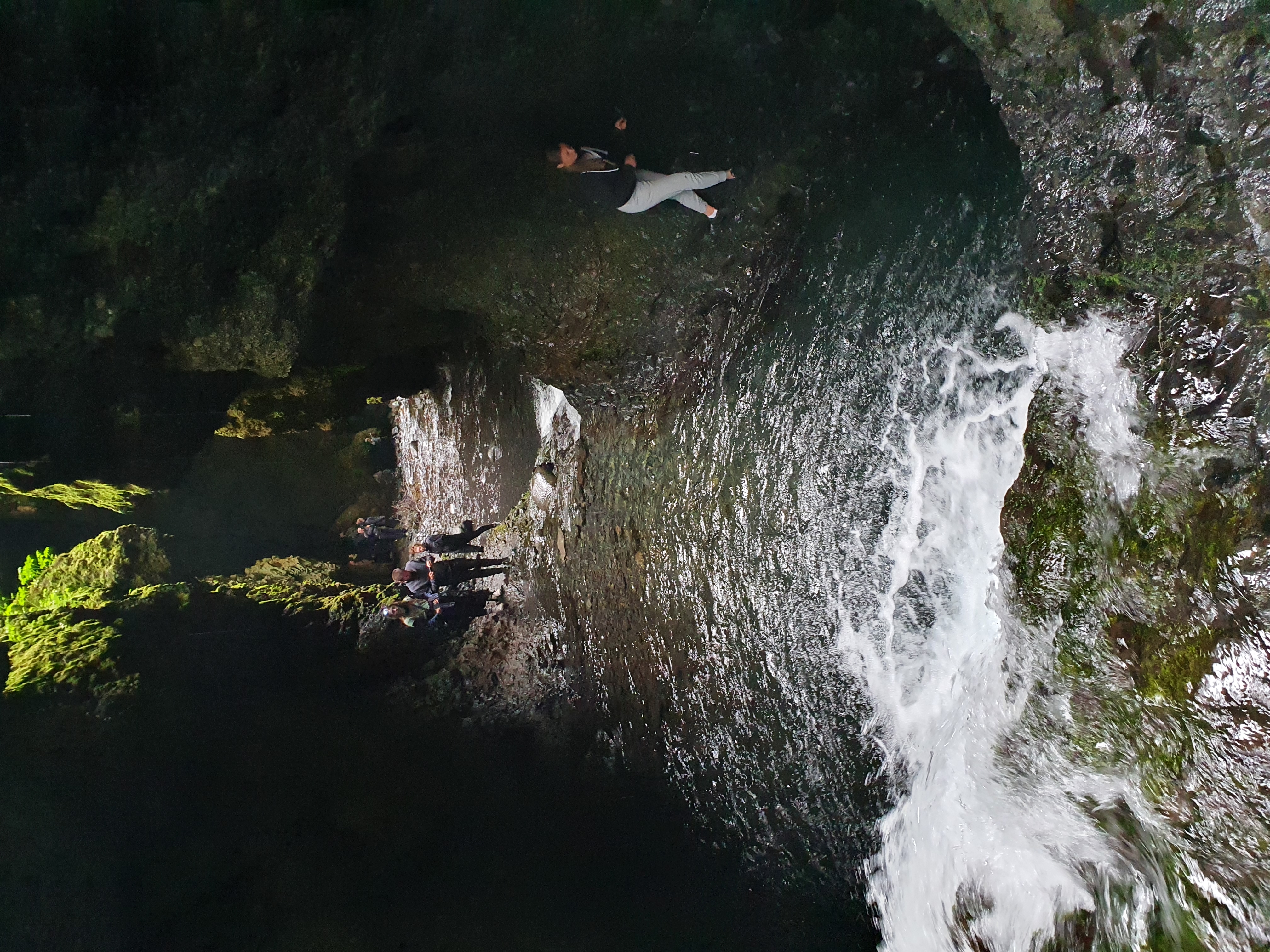 Swimming in the pool beneath the waterfall inside Nauthúsagil ravine