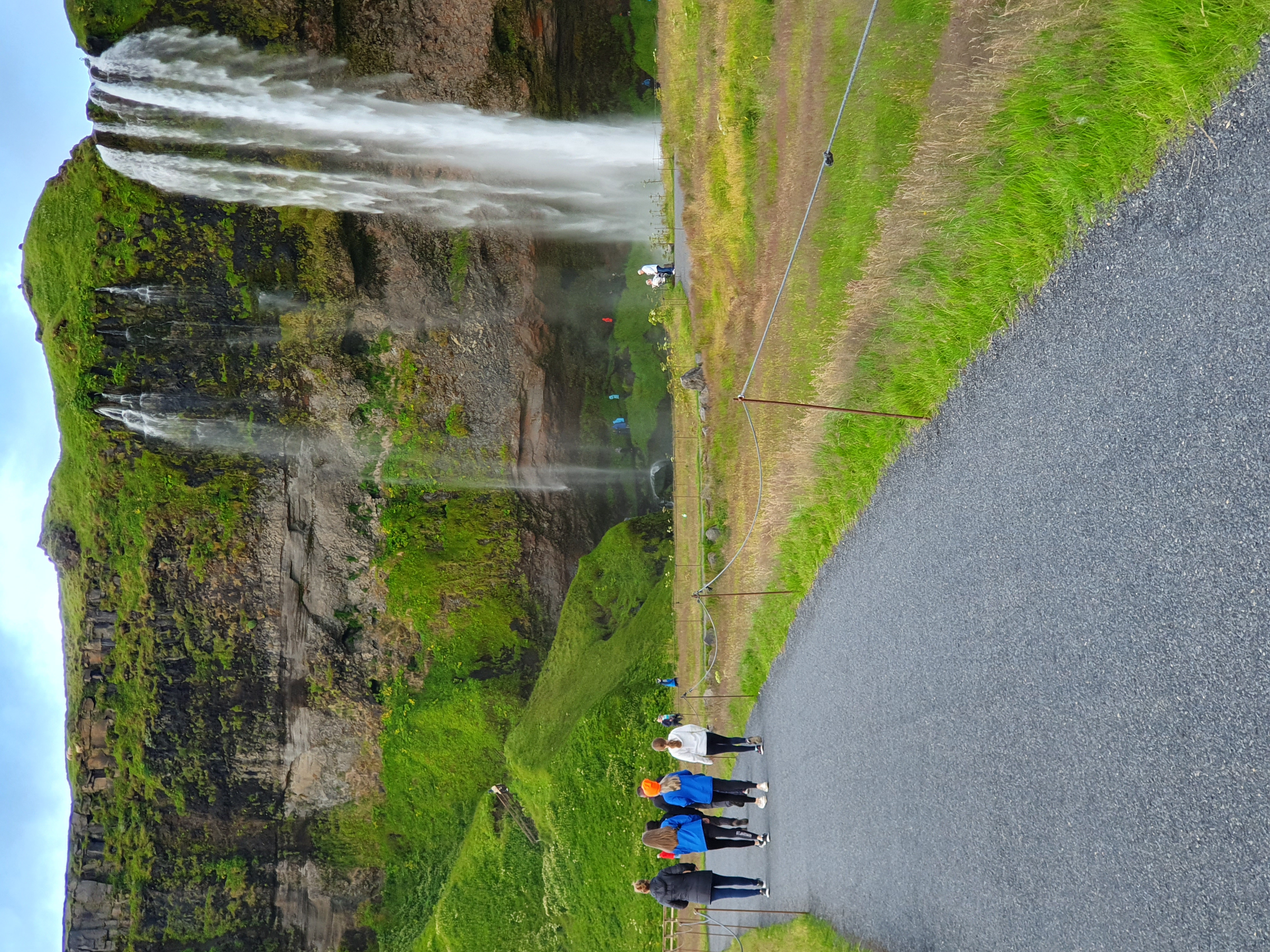 Seljalandsfoss waterfall surrounded by lush green cliffs
