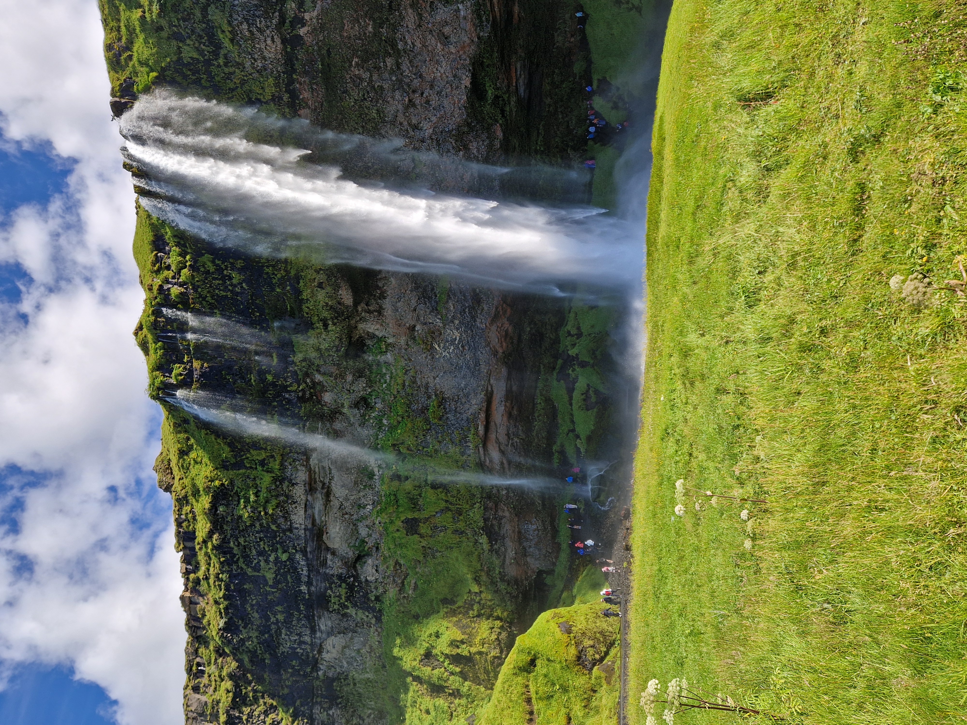 View from behind Seljalandsfoss waterfall looking through the cascade